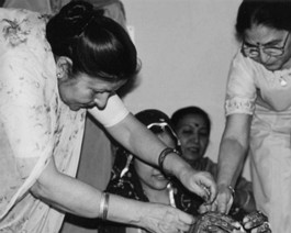 Mom-01 brides aunts (my Mom) tying Choora