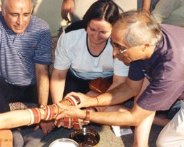 Gagi-Choora Uncles putting bangles on the bride's wrist.